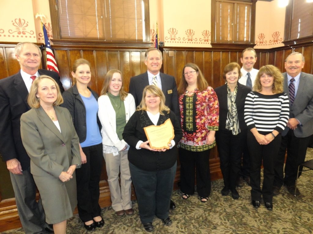 Delaware County Records Center Coordinator Christine Shaw (holding plaque) and her staff received the 2015 Achievement Award from the Ohio Historical Records Advisory Board during the county commission meeting on November 16, 2015. Pictured from left to right, County Prosecutor Carol O'Brien, Commissioner Gary Merrell, Records Technician Alison Miller, Records Technician Megan Henry, Commissioner Jeff Benton, Ohio Historical Records Advisory Board member Pari Swift (State of Ohio, Office of the Attorney General), Commissioner Barb Lewis, Ohio Historical Records Advisory Board member Stephen Badenhop (Union County Records Center), Records Technician Sharrie Doubikin and County Auditor George Kaitsa.